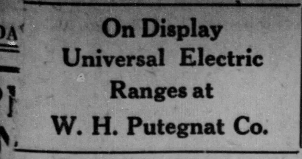 Text-only advertisement in bold type reading "On Display Universal Electric Ranges at" followed by a company name, enclosed by horizontal rules.